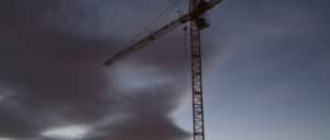 Stormy skies with large industrial crane jutting out