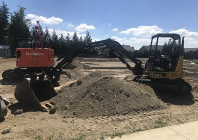 Two excavating machines at a construction site in Lynden Whatcom County